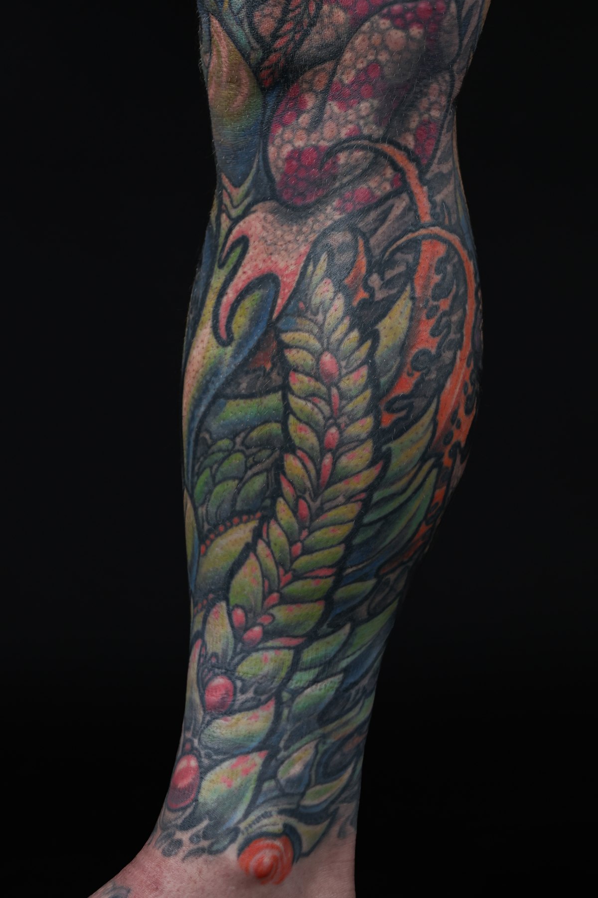 Color biomechanical lower-leg tattoo detail by Josh Standley