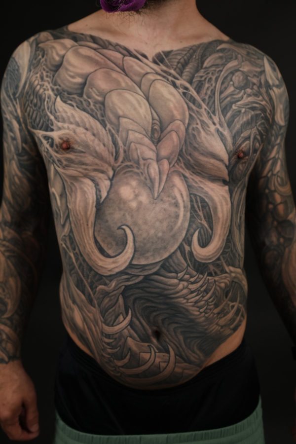 Black and grey biomechanical chest and torso tattoo by Josh Standley