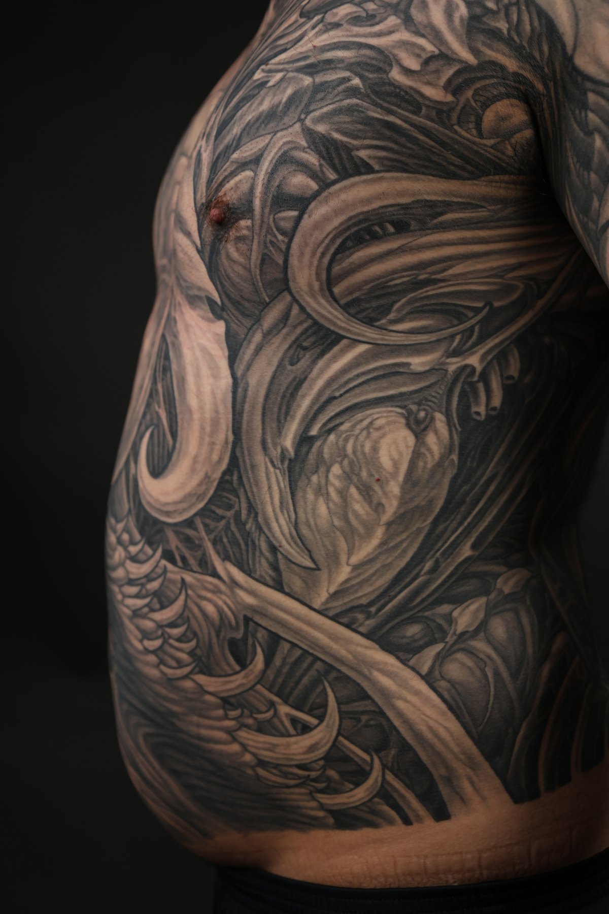 Black and grey biomechanical torso tattoo detail by Josh Standley