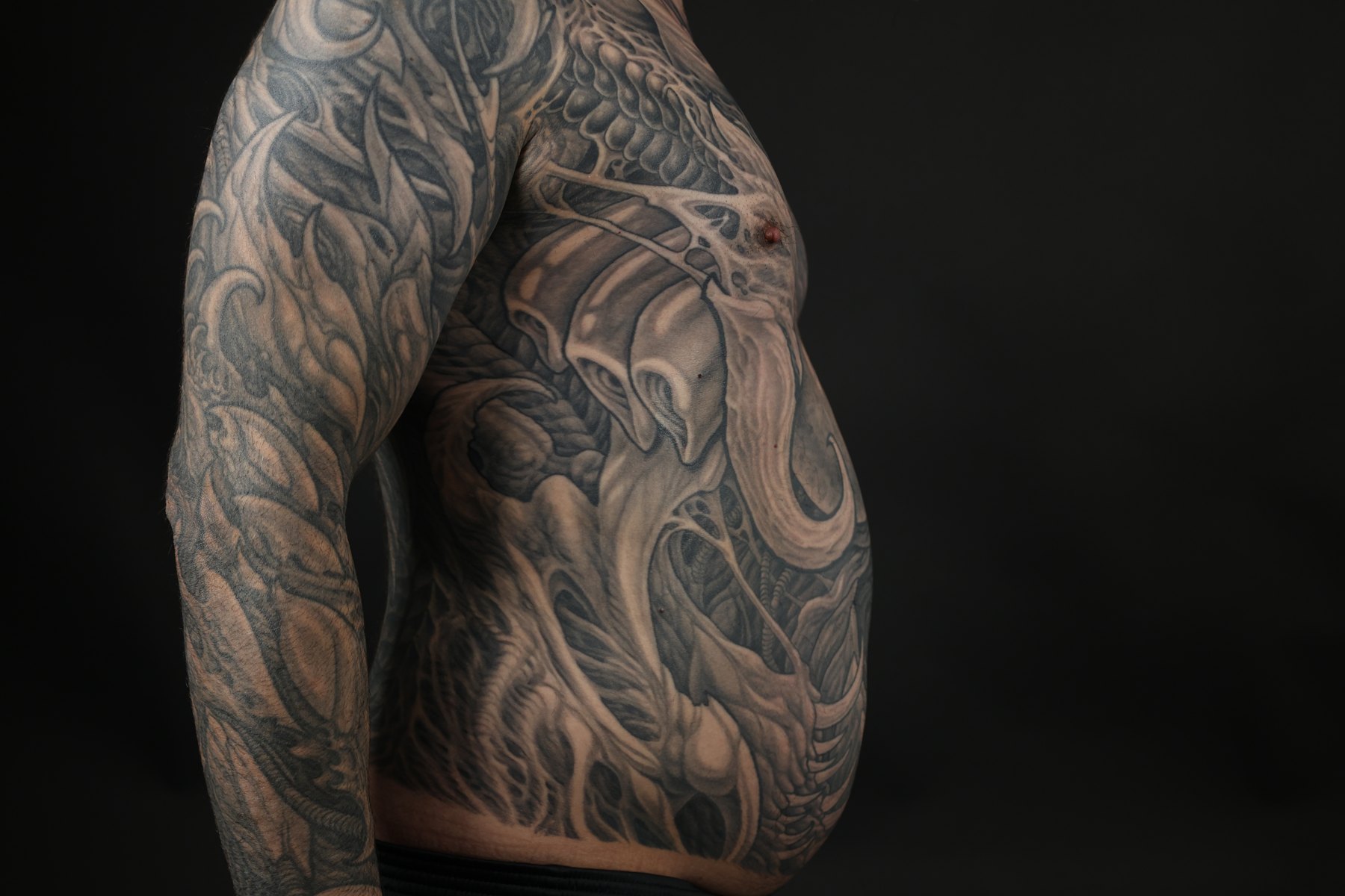 Black and grey biomechanical shoulder tattoo by Josh Standley