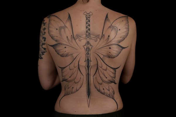 Fine line sword and butterfly wings tattoo across the back