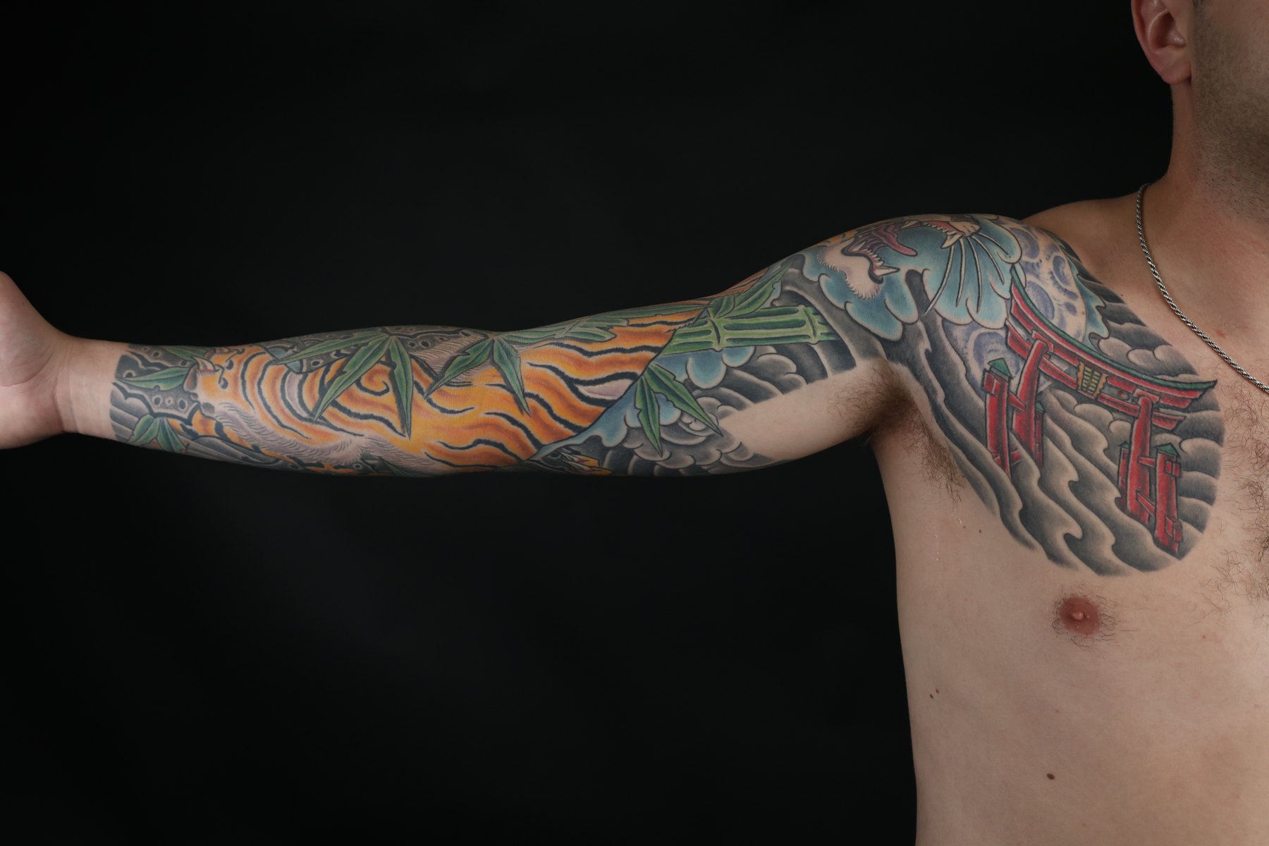 Japanese sleeve and chest tattoo viewed from the side