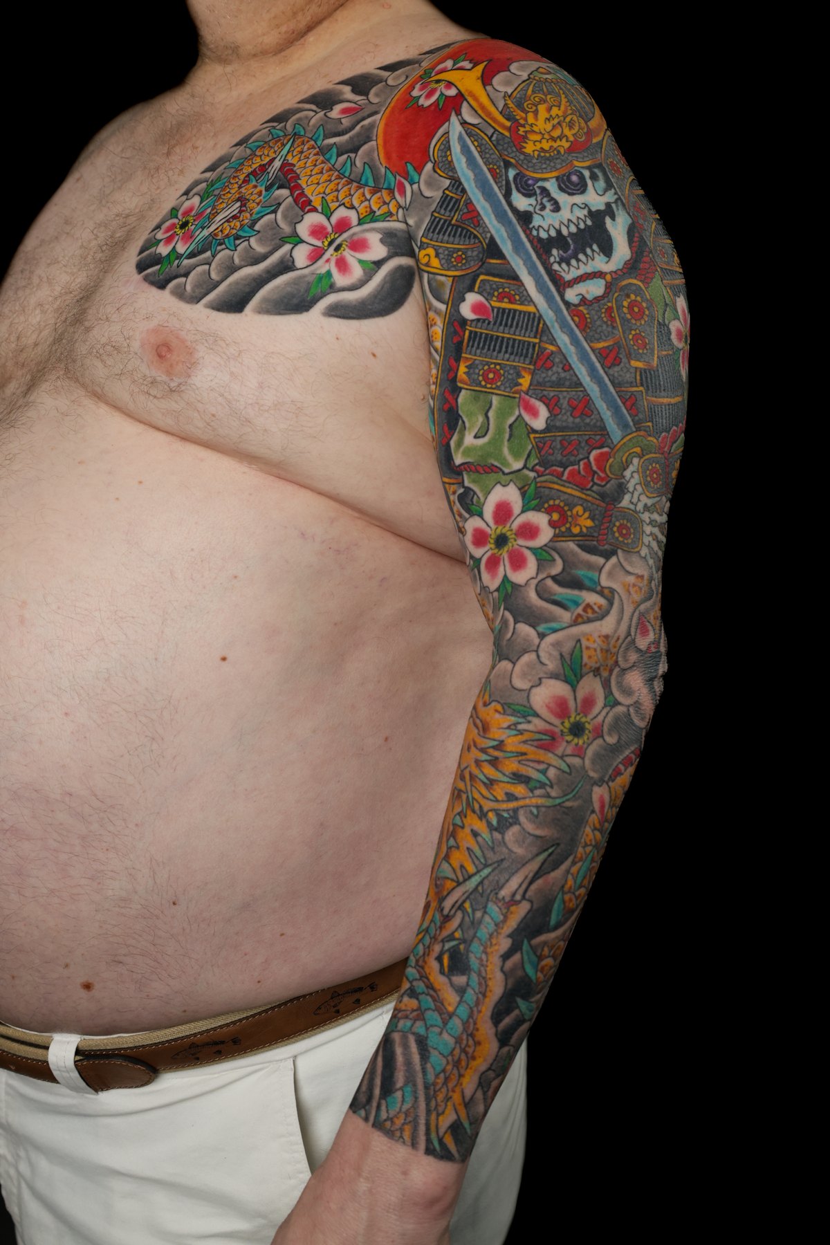 Japanese floral chest and arm tattoo