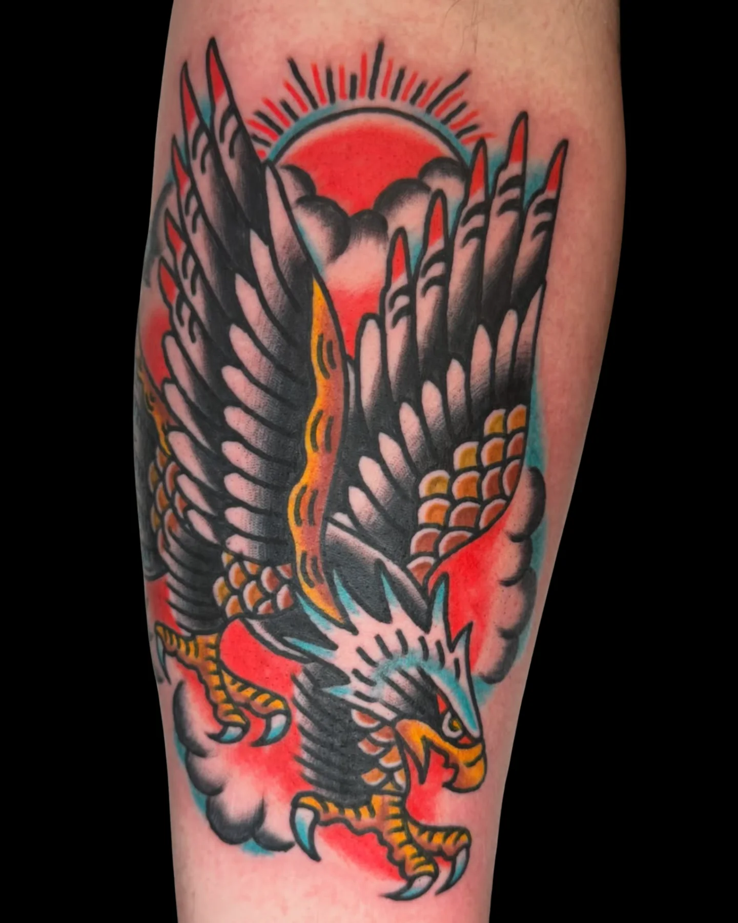 Traditional eagle tattoo with a red sun by Chris Harris