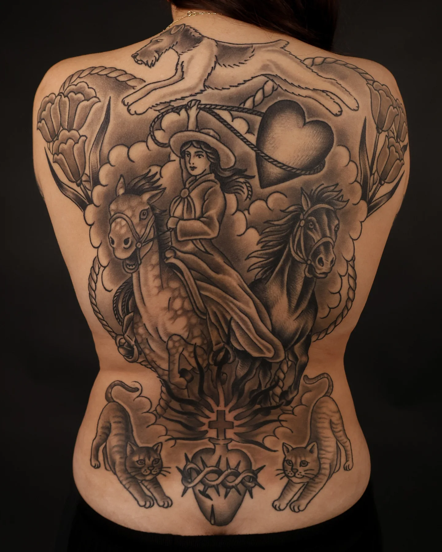 Black and grey full-back tattoo with layered figures by Nate Haynes