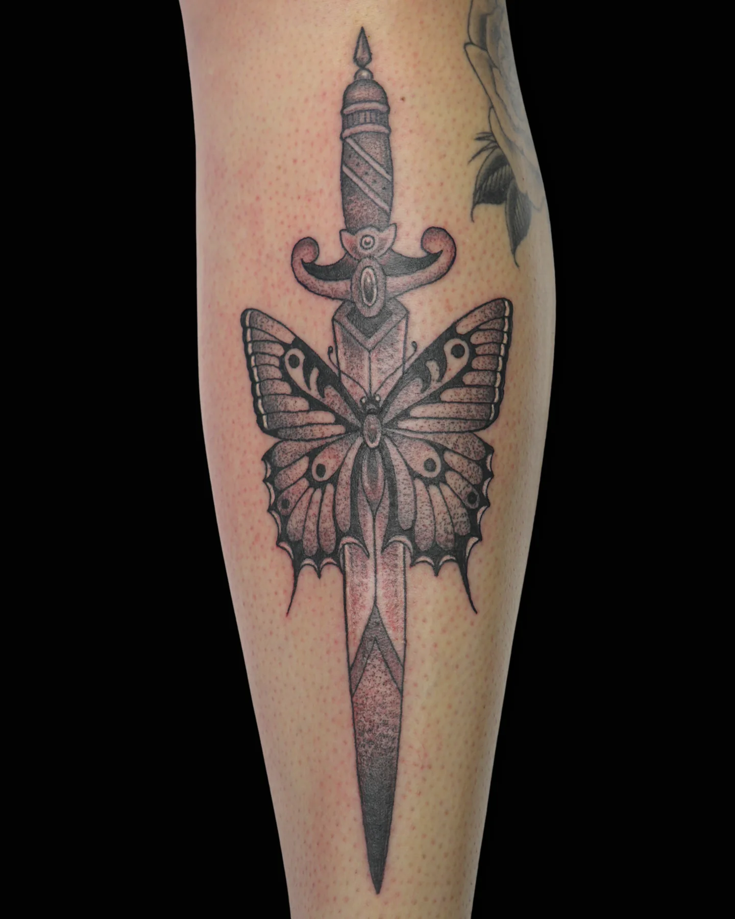 Black and grey butterfly and dagger tattoo by Nate Haynes