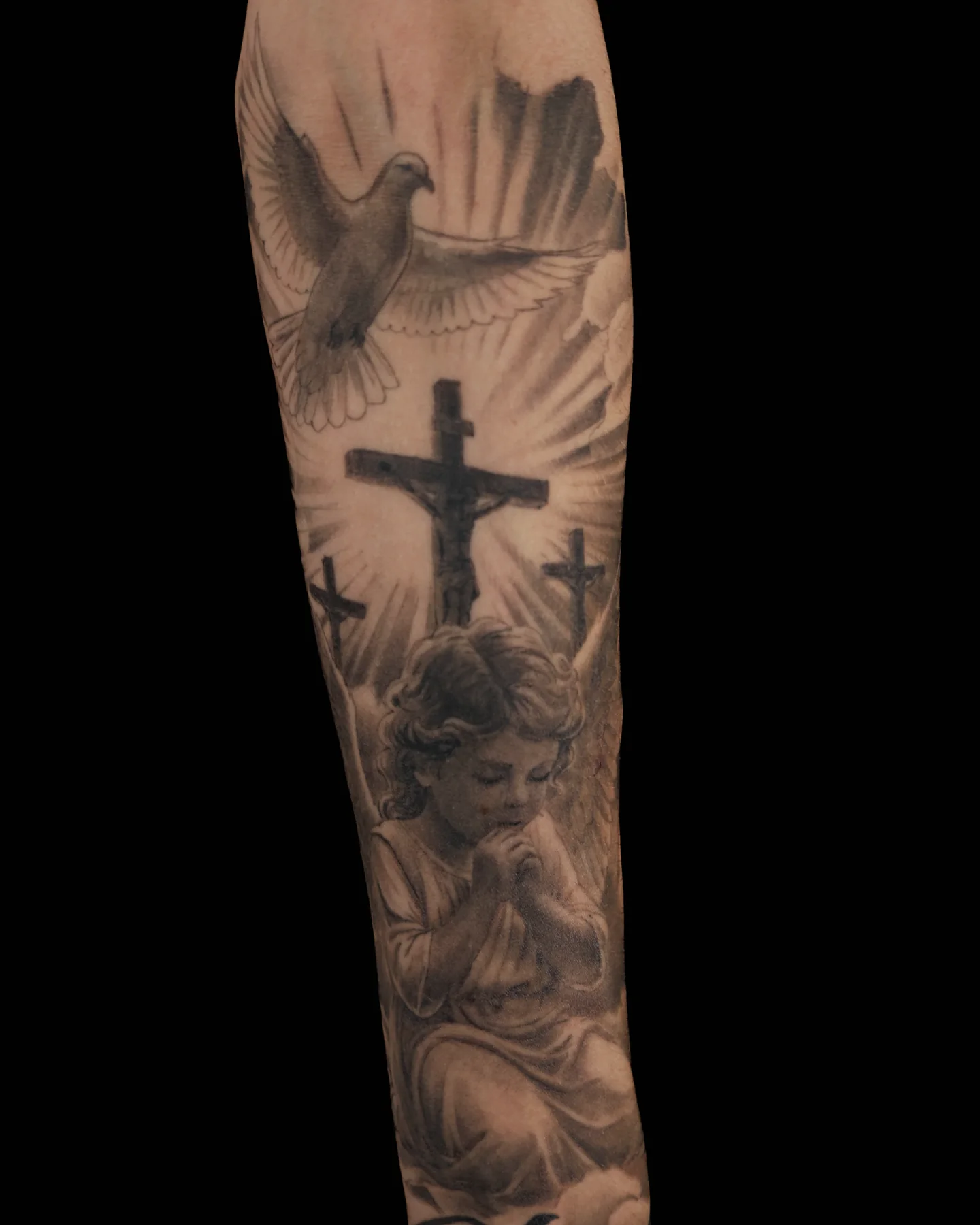 Black and grey memorial tattoo with a cross and praying hands by Brian Pittman