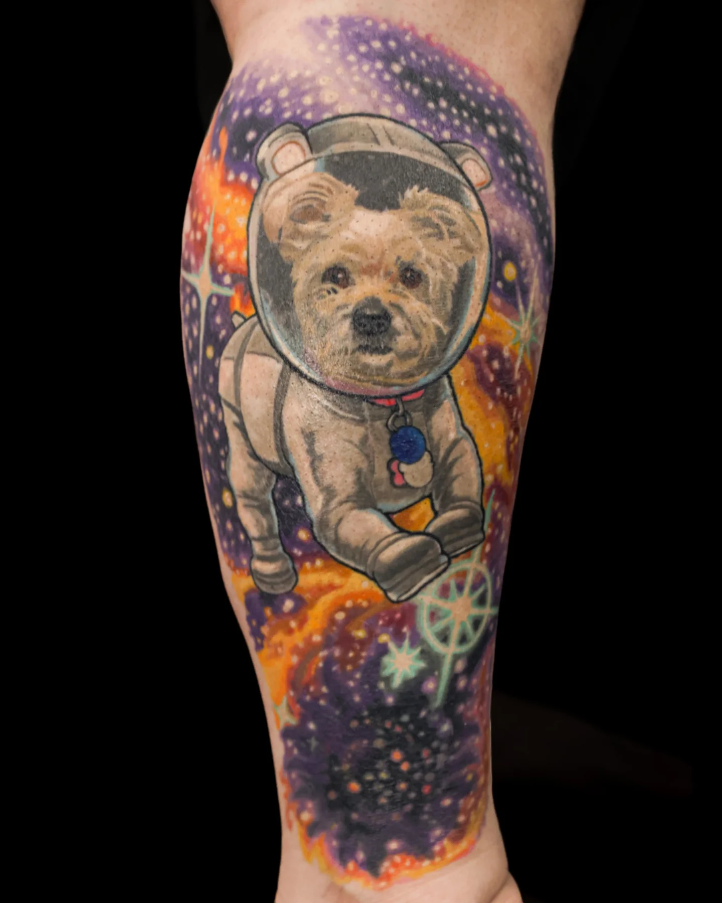 Surreal dog astronaut tattoo with a colorful space background by Brian Pittman