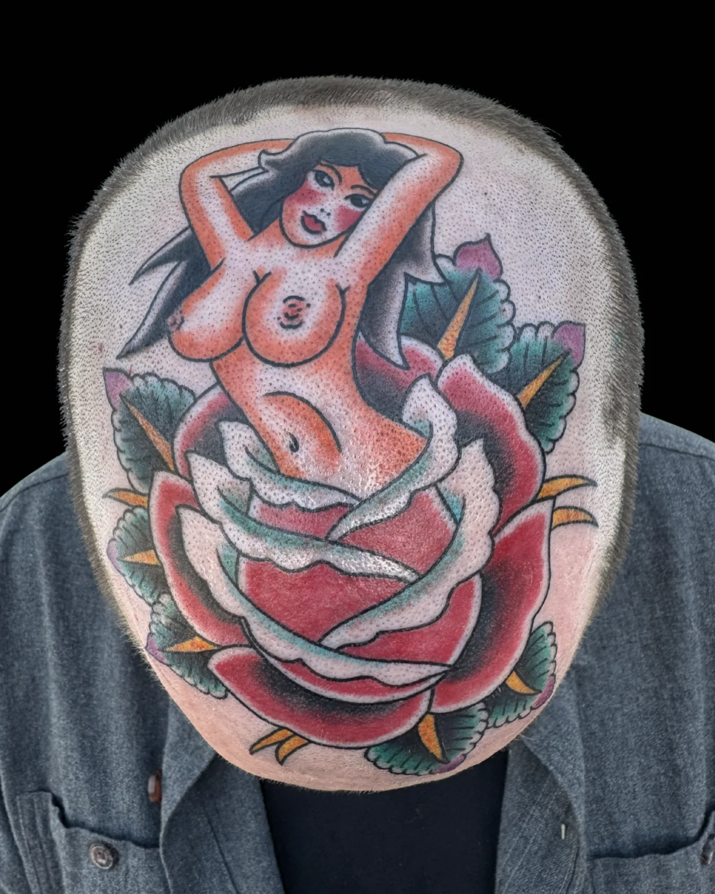 Traditional pin-up and rose tattoo by Chance Ewing