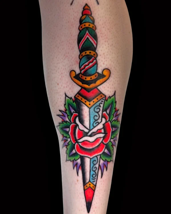 Traditional dagger and red rose tattoo by Chris Harris