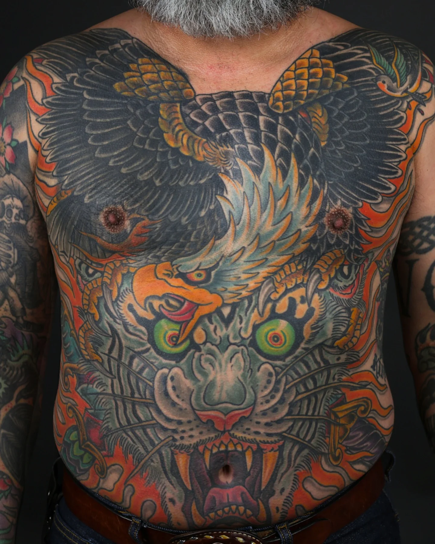 Color torso tattoo with eagle and horned mask by Jedidia Reid