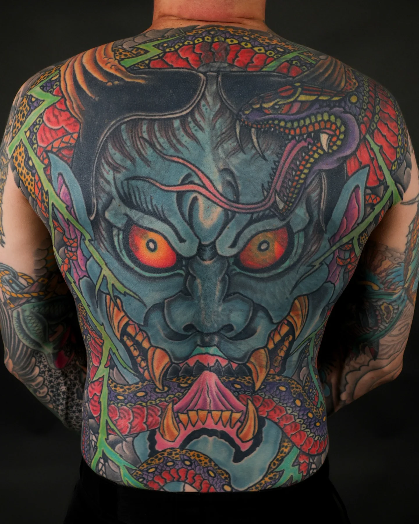 Japanese full-back tattoo with a blue horned mask and dragons by Jedidia Reid
