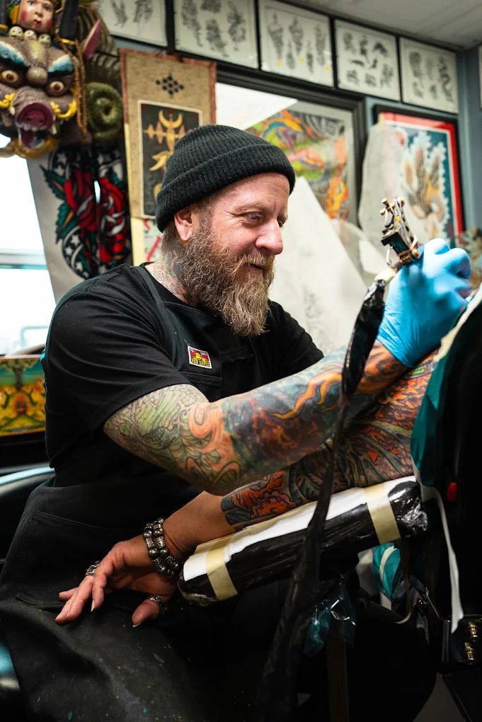 Jedidia Reid tattooing a client at Element Tattoo
