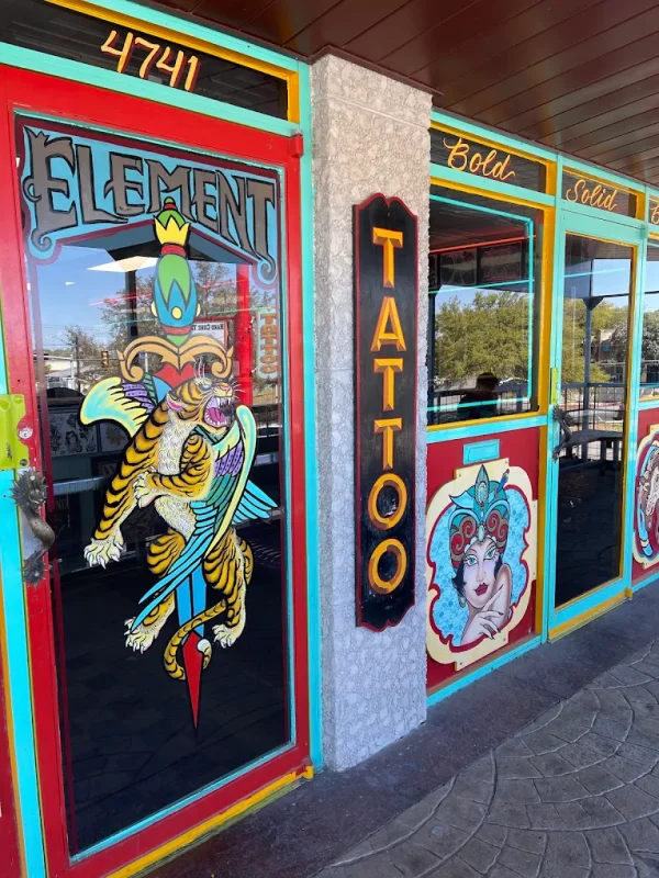 Element Tattoo entrance with colorful tiger artwork and a vertical TATTOO sign